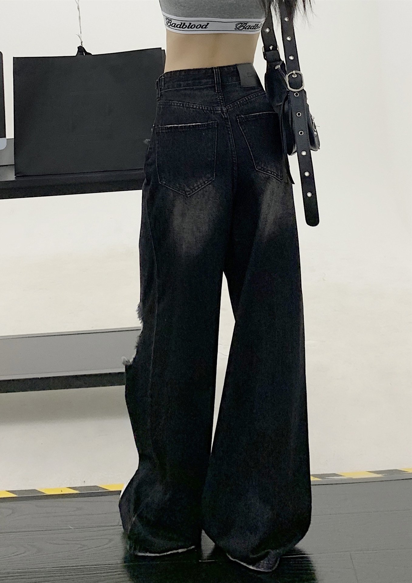 Model Wearing Black Ripped Jeans